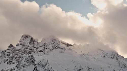 Snow Covered Mountain Peaks in Canadian Nature Winter Season Dramatic Cloudy Sunset BC Canada