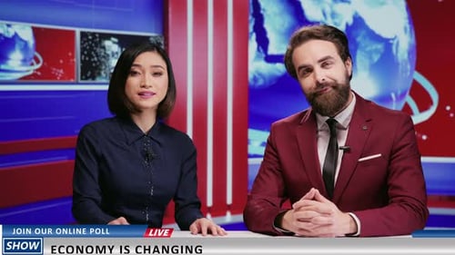 News Anchors Presenting in Modern Broadcast Studio