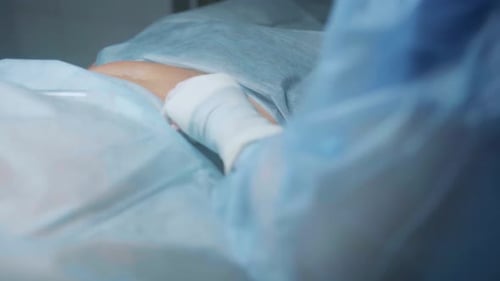 Surgeon Injecting Patient in Hospital Operating Room