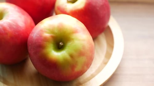 Close Up of Fresh Apple in a Bowl on Wooden Table