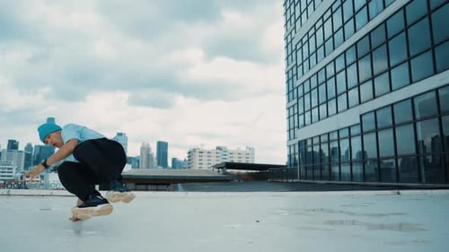 Stylish caucasian dancing man performing break dance at skyscraper. hiphop.
