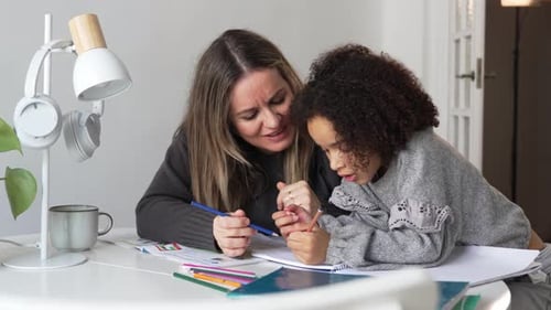 Mother Helping Child with Drawing Homework at Home