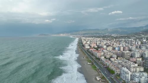 Aerial Video Ocean Storm with Large Waves and Dazzling Foam Designs Enhances the Sandy Coastline