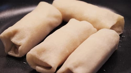 Rolled Stuffed Pancakes Cooking in a Pan