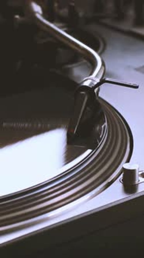 DJ Headshell on Spinning Turntable Listening the Music on Vinyl Vertical Footage