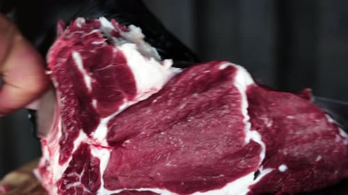 Raw Beef Cut with Knife in Close Up