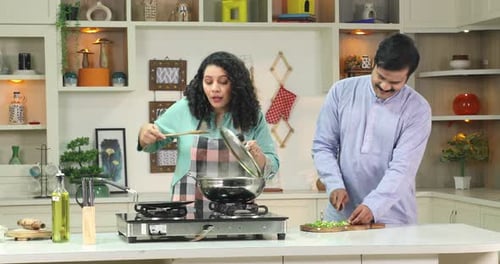 Woman Cooking Meal for Man in Home Kitchen