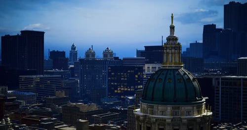 View of City Skyline with Historic Dome Structure During Twilight