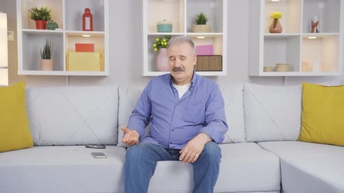 Alone and sad old man at home.