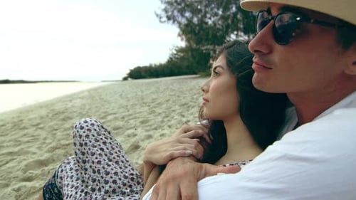 Couple in Love, Cuddling on the Beach, Laying in the Sand, Looking