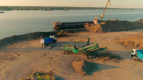 Excavator Trucks and Cranes Working at the Construction Site