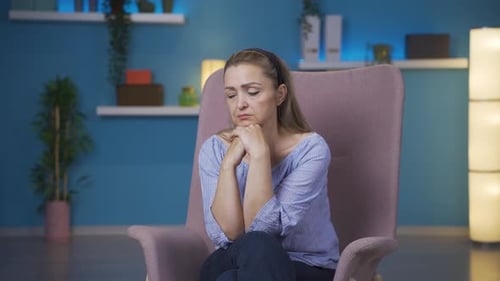 Worried Woman Feeling Emotional in Lavender Armchair