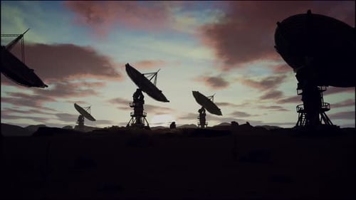 Satellite Dishes On Field Against Cloudy Sky During Sunset