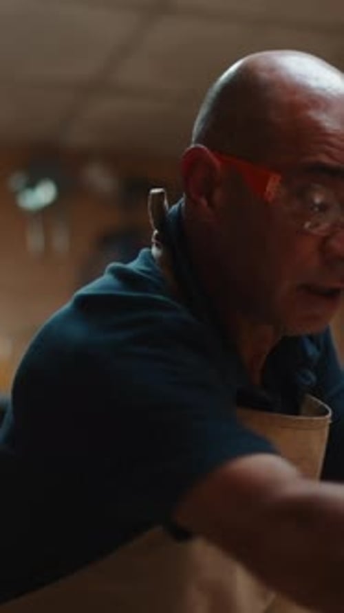 Man Puts on Safety Gear, Prepares for Woodworking