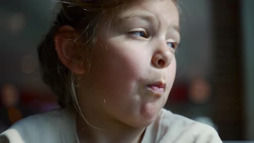 Girl Grimaces and Scrunches Face in Close Up