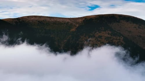 Clouds Rolling Over a Mountain During Early Morning in the Wilderness