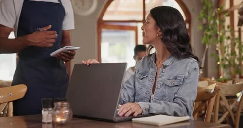 Cafe, waitress and freelancer customer with laptop, typing feedback for restaurant review blog