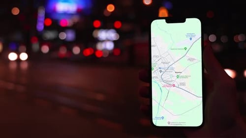 Phone with Map App at Night in City