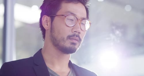 4k video footage of a handsome young businessman writing notes on a whiteboard in an office