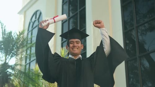 Graduate with Diploma Celebrating Victory and Success