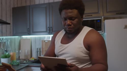 Man Uses Tablet Then Grabs Plates of Food