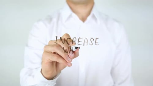 Writing Increase Wage on Clear Surface