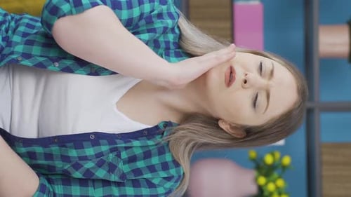 Woman in Pain Touching Her Face and Neck