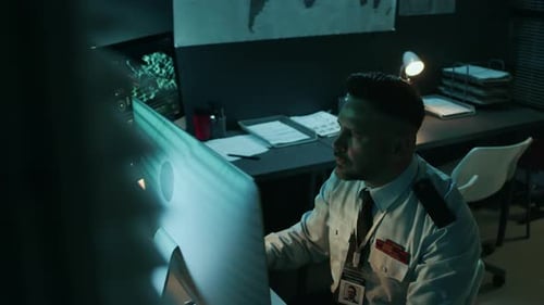Caucasian Serviceman Working on Computer at Military Command Center