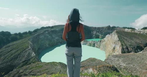Person Standing on Mountain Overlooking Lake