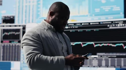 Businessman Smiles Using Smartphone Before Data Display