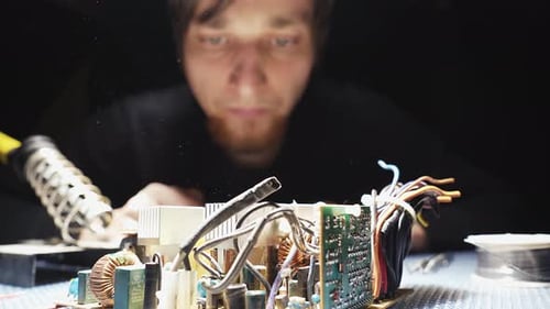 Man Repairing Electronic Circuit Board