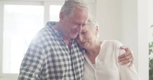 Senior Couple Embracing with Love Indoors