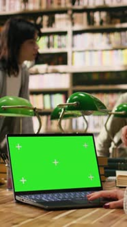 Vertical Video Green Screen Chroma Key on Laptop at Library Wooden Desk