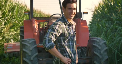 Portrait of a beautiful young farmer (student) working in the field with a tractor, successful smi