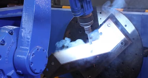 Smoke And Sparks From Robotic Welder Welding Metal Structure In A Factory. static