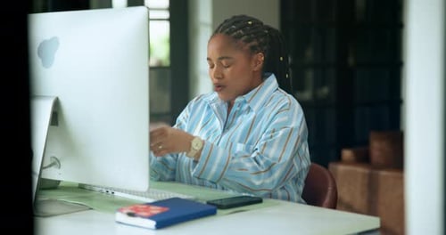 Tired Woman at Computer Rubbing Eyes in Office