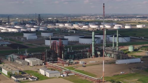 Aerial View of Vast Industrial Refinery Complex with Numerous Storage Tanks