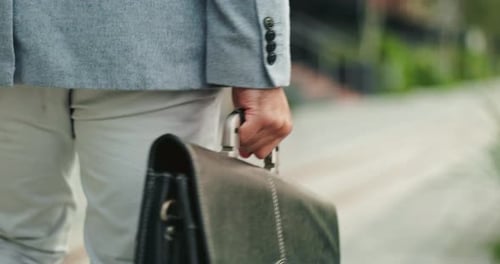 Hands, briefcase and business person in city with travel, walking and morning commute as lawyer