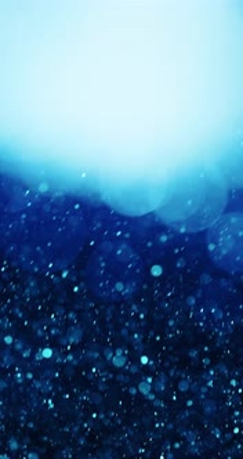 Cascade Of Glowing Blue Particles And Bokeh