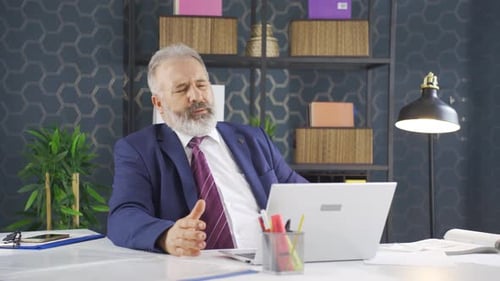 Worried Businessman Working at His Desk