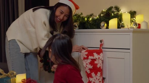Festive Mother and Child Decorating Christmas Stocking