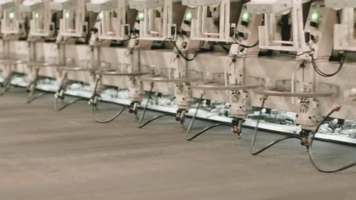 Synchronized assembly line in an automotive factory performing technological task.