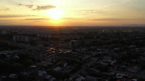 a Sunset Over a City with Buildings and a Sky Line in the Background with Clouds in the Sky and a