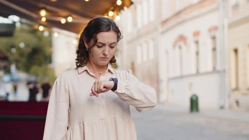 Woman Checks Watch and Runs on City Street