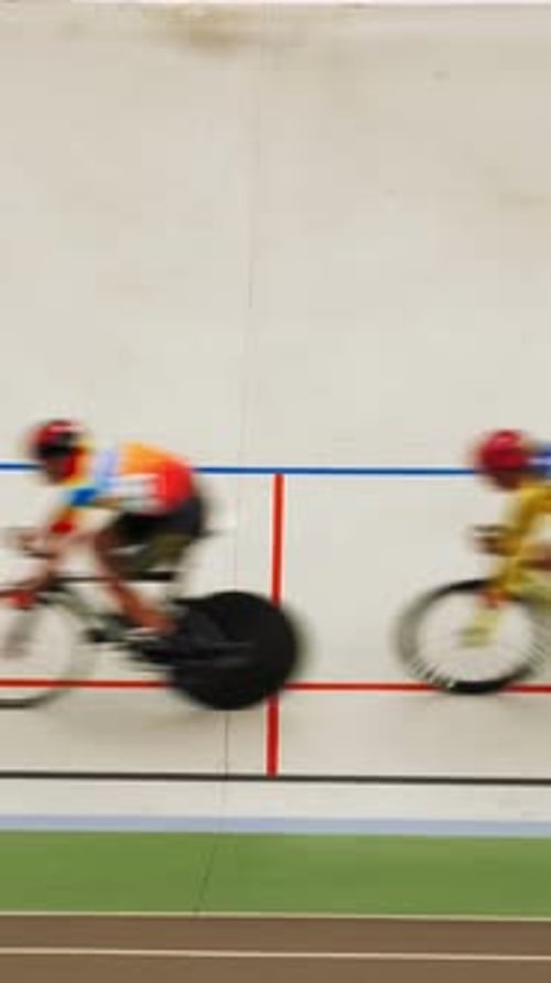 Professional cyclists riding fast on bicycles with fixed gear. Vertical video