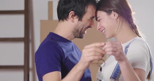 Portrait of a couple in love seated on the floor and they just bought a house and are moving. The