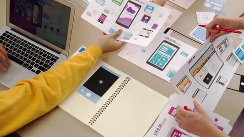 Team Designing Mobile App Interfaces in Workplace Setting