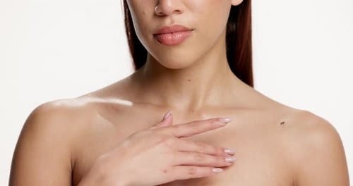 Skincare, chest and and beauty with hands of woman in studio for body care