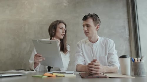 Business Presentation by Two Young Adults in Office