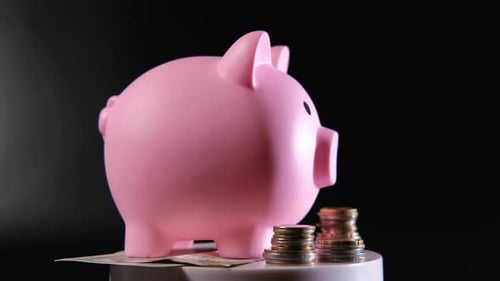 Piggy Bank with Coins on Dark Backdrop